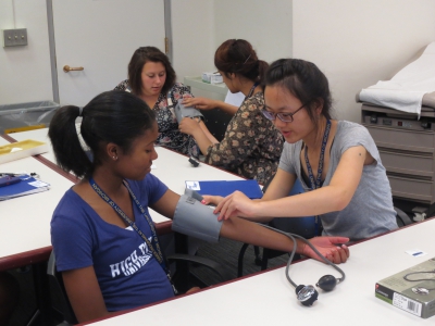 The students practice taking each other's blood pressure