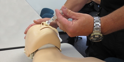 A deputy practicing administering Naloxone