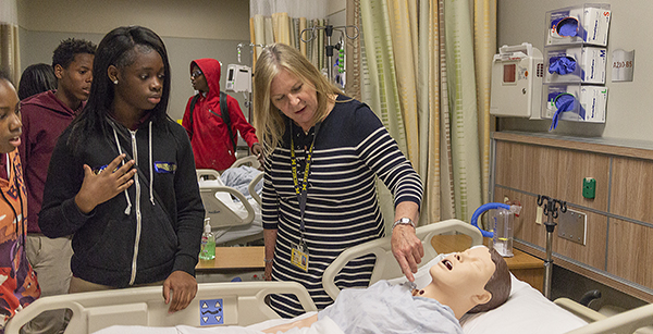 UMSN's Judi Policicchio explains some of the features of the high-tech mannequins in UMSN's Clinical Learning Center