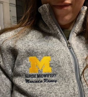 Student in jacket with Midwifery logo