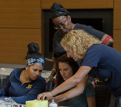 Zielinski instructs midwifery students during a suturing workshop